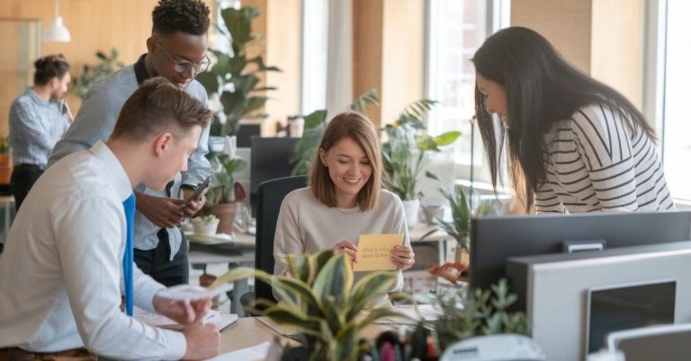 Get well soon messages for colleague image showing coworkers giving a recovery card and support in the office